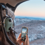 Person enjoying a 20 minute helicopter tour over Borealis Basecamp