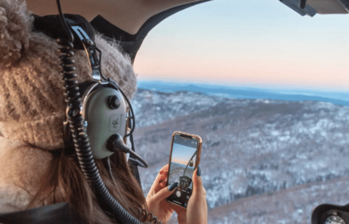 Person enjoying a 20 minute helicopter tour over Borealis Basecamp
