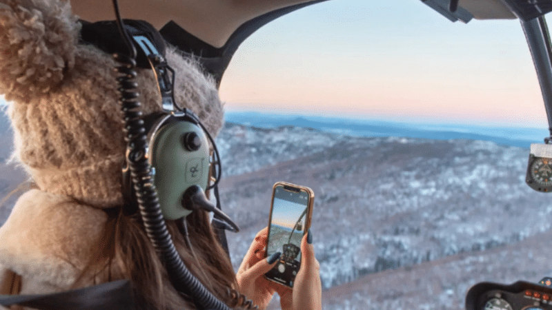 Person enjoying a 20 minute helicopter tour over Borealis Basecamp